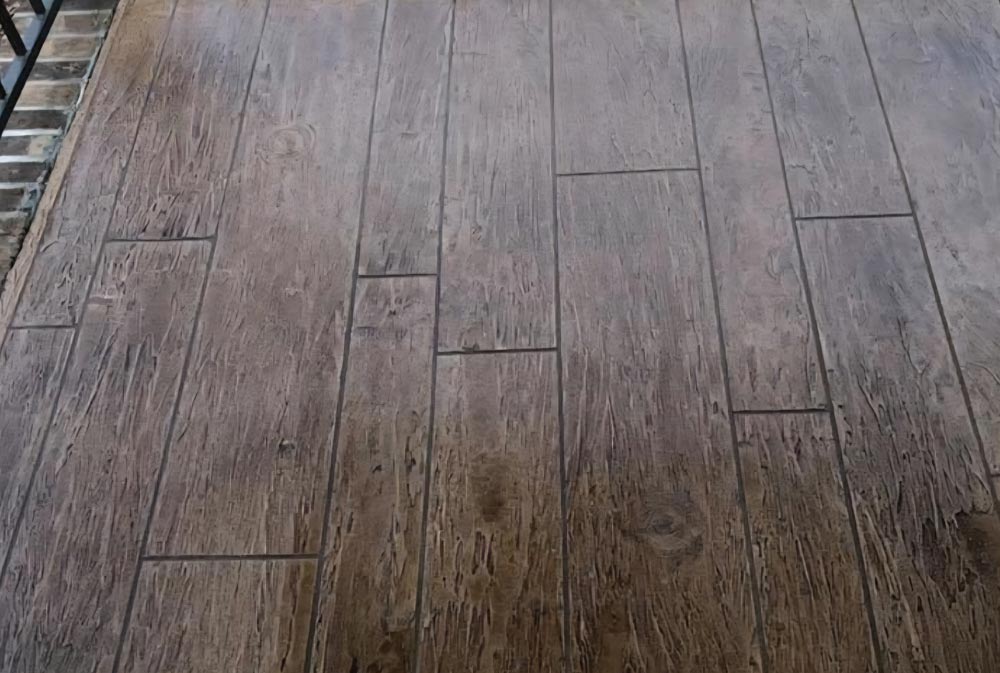 Brown tiles with a wood grain pattern arranged in a staggered layout, resembling wooden floor planks.