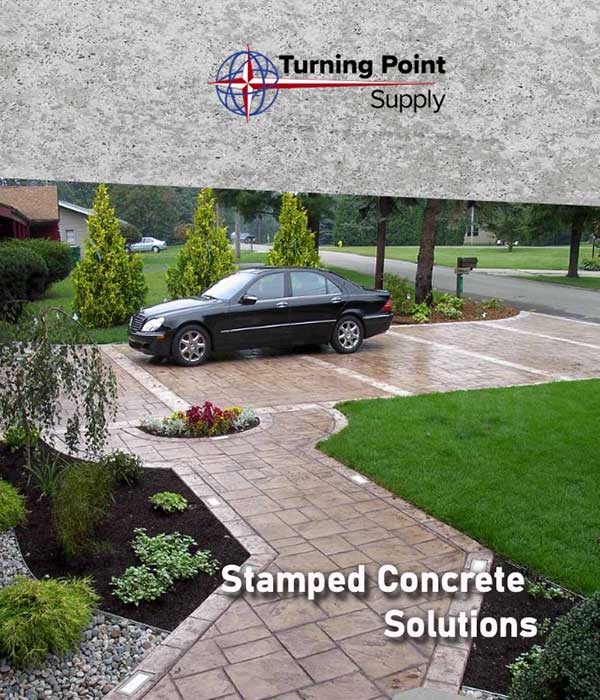 A black car on a stamped concrete driveway with landscaping, featuring "Stamped Concrete Solutions" text.